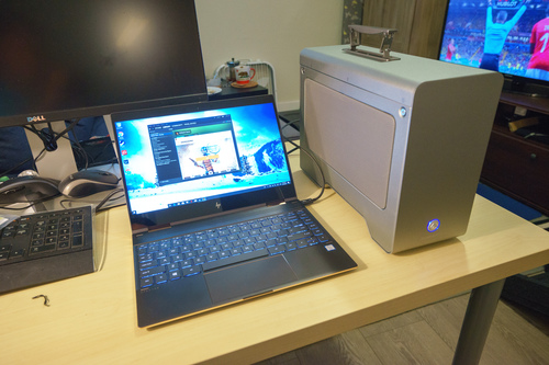 A rather big Akitio Node Pro placed next to the laptop